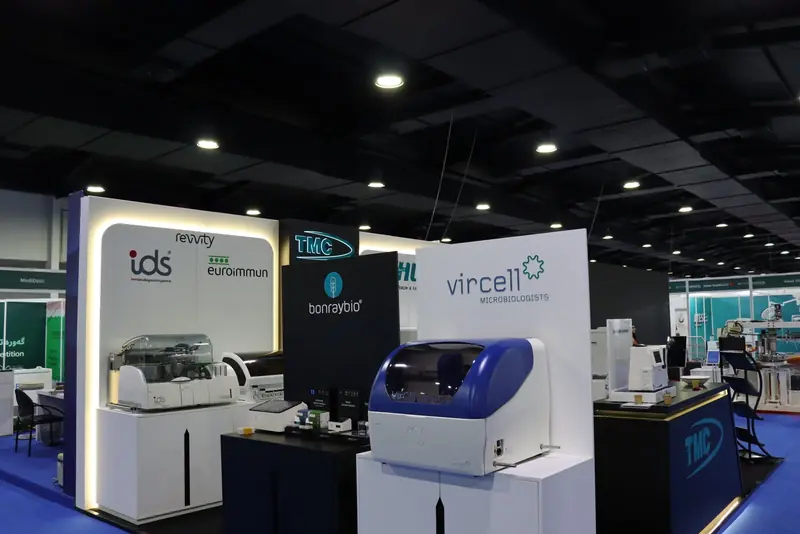 Corner of the stand with Revvity IDS and EUROIMMUN wall and analysers, Bonraybio panel, Vircell VirClia analyser and the TMC counter