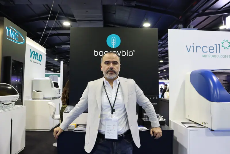 Staff member standing in front of the Bonraybio panel, with the Vircell VirClia analyser on the right