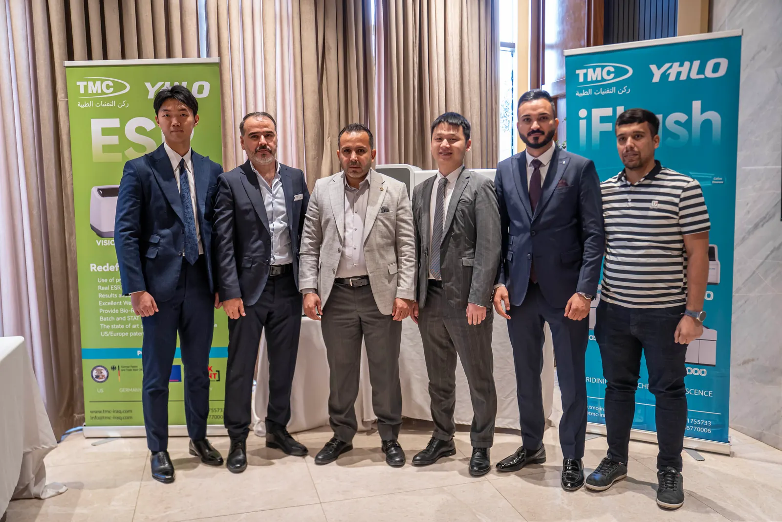 The TMC and YHLO teams between the ESR and iFlash displays at the TMC × YHLO scientific day, Baghdad, May 2025